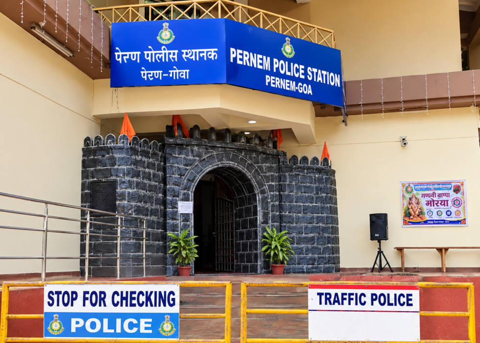 Pernem Police Station, Goa, featuring its distinctive stone-arch entrance and blue police station signboard.