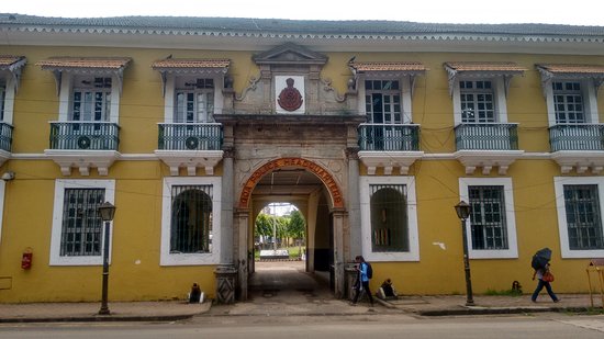 A colonial‑style yellow building in Panaji, Goa, featuring the central archway inscribed “GOA POLICE HEADQUARTERS” and the official red Goa Police emblem above it.